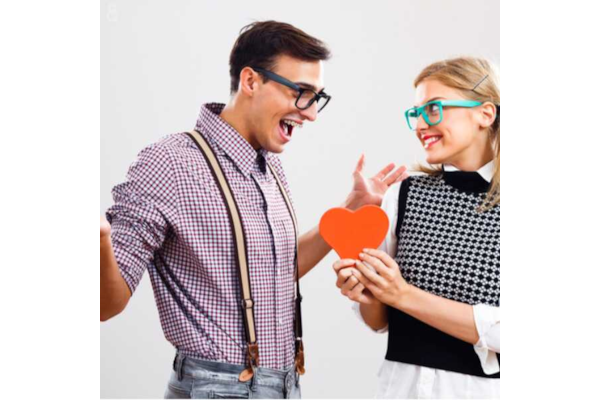 geeky couple holding a fake love heart