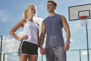 tall man and woman playing basketball