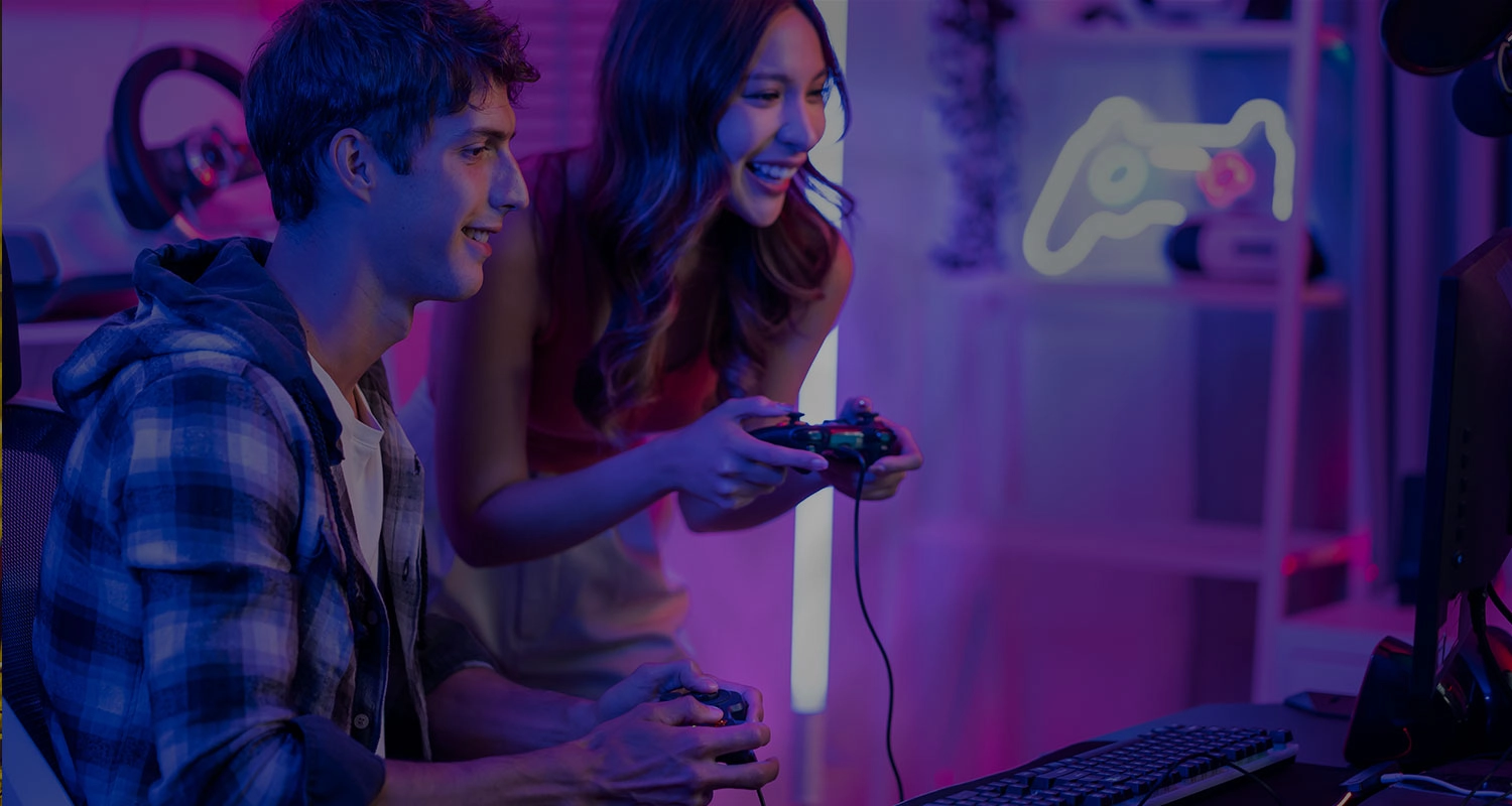 Two gamers smiling while playing a co-op video game, symbolising connections through Gaming Singles.